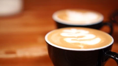 Close up slow motion view on beautiful milk foam latte art on cappuccino coffee Stock Footage 105454294