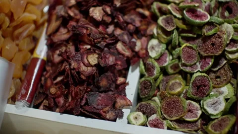 Close-up slow-motion view capturing dehydrated fruits like dried figs Stock Footage 297617904