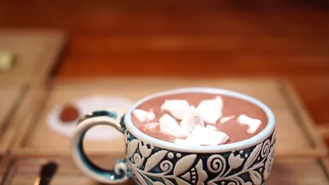 Close up slow motion view on cinnamon put on marshmallow cacao in beautiful Stock Footage 104414817