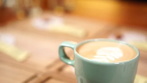 Close up slow motion view on cute minimalistic coffee cup with cappuccino milk Stock Footage 104510265