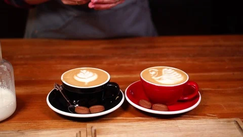 Close up slow motion view on female barista serving cappuccino coffee cups with Stock-Footage 104514841
