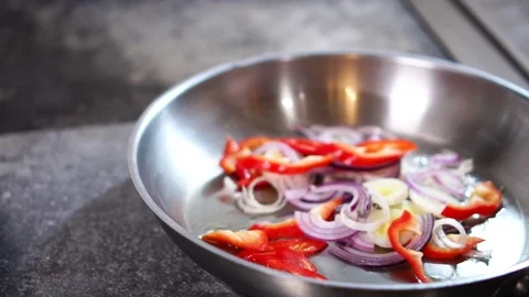 Close up slow motion view on fried beef steak meat put on frying pan with fresh Stock Footage 105457443