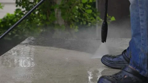 Close up slow motion view outdoor floor cleaning with high pressure water jet Stock Footage 157007327