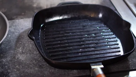 Close up slow motion view on piece of beef steak raw meat put on oily surface of Stock Footage 105895004
