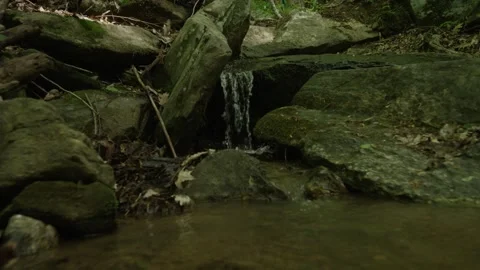 Close up slow motion of water flowing over rocks in creek in North Carolina Stock Footage 242865833