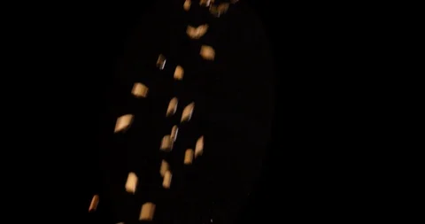 Close up slow motion of wheat grains falling down on black background. Shot in Stock Footage 114311329