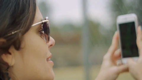 Close-up in slow motion of woman using mobile to take video Stock Footage 117079239