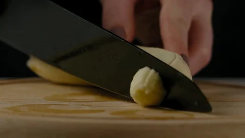 Close-Up, Slow Motion, Woman's Hand Slices a Banana on the Kitchen Board Stock Footage 103488830