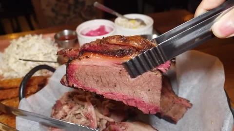Close-up of Slow-Smoked Texas BBQ Beef Brisket with Pink Smoke Ring Stock Footage 338212819