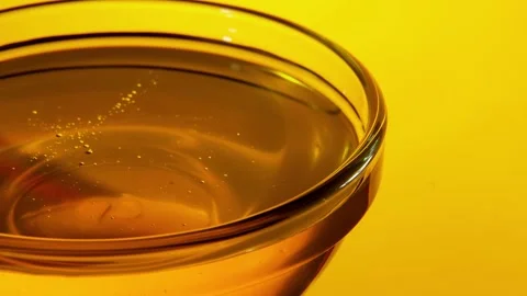 Close-up slow view of a small glass bowl of honey Stock Footage 132746259
