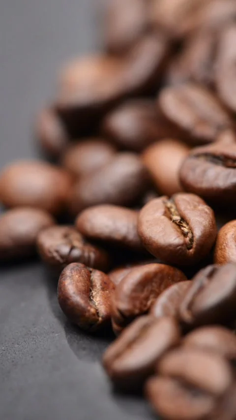 Close up of slowly rotating whole coffee beans background Stock Footage 310656927