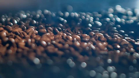 Close-up slowmo video of brown coffee beans falling down on a pile of beans Video stock 102093858