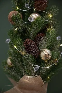 Close-up of a small artificial Christmas tree decorated with pine cones Stock Photos
