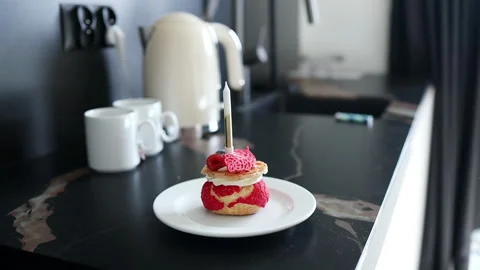 Close up of small birthday cake with strawberry and candle in bed. Stock Footage 340142860
