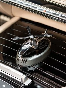 Close up of small black metal stinkbug helicopter model inside car Stock Photos