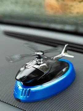 Close up of small black metal stinkbug helicopter model inside car Stock Photos
