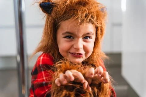 Close up of a small boy dressed as werewolf gesturing while scaring the camera Stock Photos