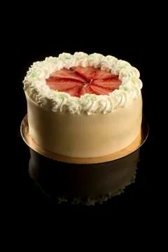 Close up of small cake on black table Stock Photos