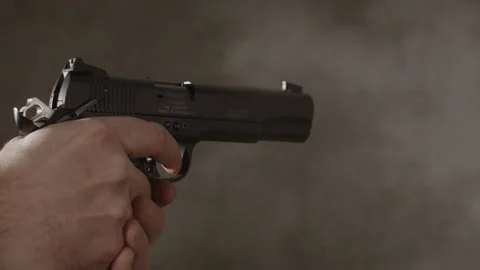 Close up of small caliber pistol being fired rapidly in slow motion Stock Footage 229635947