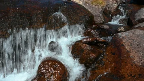Close up of small cascade over rocks Stock Footage 148252516