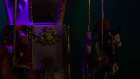 Close up of a small Christmas decoration carousel with colored lights Video stock 165478250