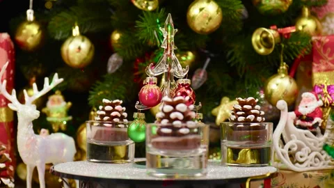 Close-up of a small Christmas tree surrounded by pine cones rotating Stock Footage 260887775