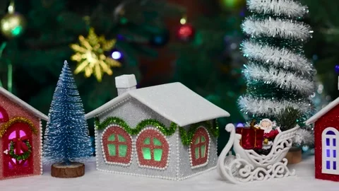 Close-up of small Christmas trees standing near the gray red and pink houses Stock Footage 264680947