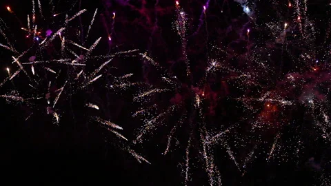 Close up small colourful fireworks shoot vertically through frame with zoom Video stock 235225812