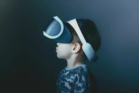 Close-up of a small five-year-old boy playing with virtual reality glasses. 3D Stock Photos