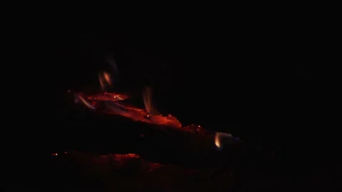 Close up of small flames of burning wood, glowing ember in bonfire campfire, 4K Stock Footage 133907655