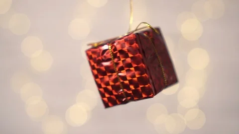 Close-up of a small gift box rotates on a blurry white background. Stock Footage 122816935