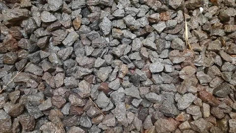 Close-up of small gray and brown gravel rocks texture background Fotos de archivo