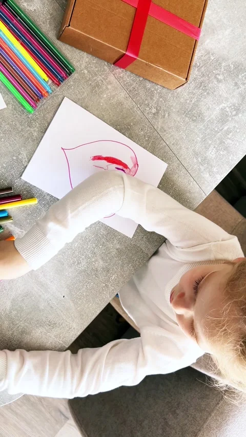 Close-up of small hands holding pencil creating childish artwork. Kid spends  Stock Footage 310135180