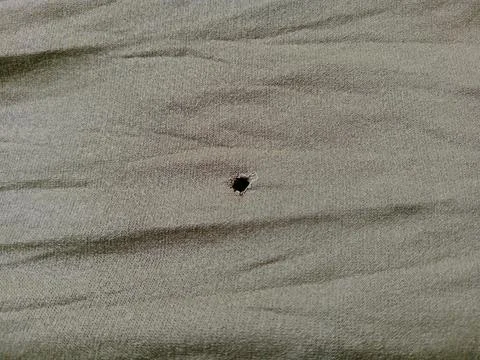 Close-Up of a Small Hole Torn in Olive Green Fabric Texture Stock Photos