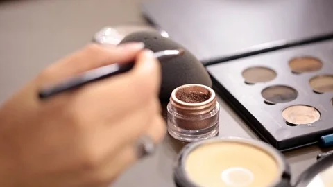 Close up of small makeup brush moving over brown Stock Footage 70003912