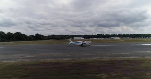 Close up of small plane taking off on a runway, chase camera drone aerial 4k Stock Footage 124647143