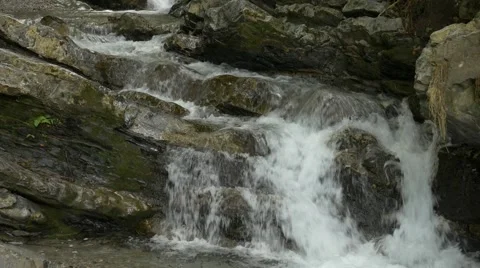 Close up of small river streaming over rocks Stock Footage 56162493