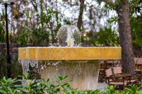 Close up of a small, round, old stone fountain Stock Photos