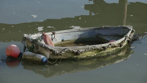 Close up of a small row boat moored in a harbour. 4K locked tripod Stock Footage 164875959