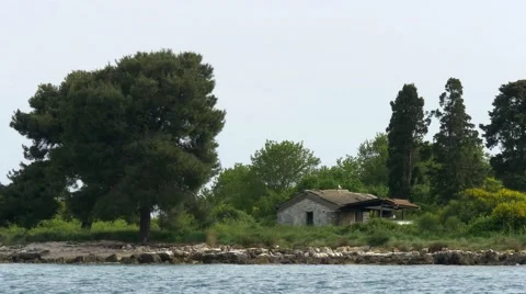 Close up of small stone cabin on green island Stock Footage 68345893