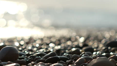 Close-up of small stones on the background of the evening sea Stock Footage 164256438