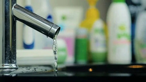 Close-up a small stream of water starts to flow from a tap in the bathroom. Stock Footage 81870672