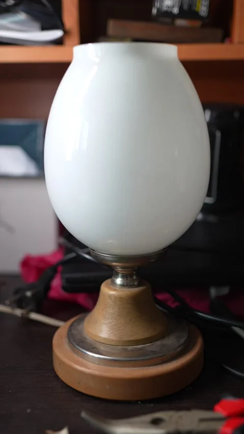 Close-up of a small table lamp featuring a smooth Stock Footage 329418296