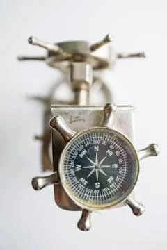 Close up small vintage compass in shape of steer Stock Photos