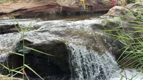 Close Up of Small Waterfall Flowing Over Rocks in Nature Stock Footage 331800604