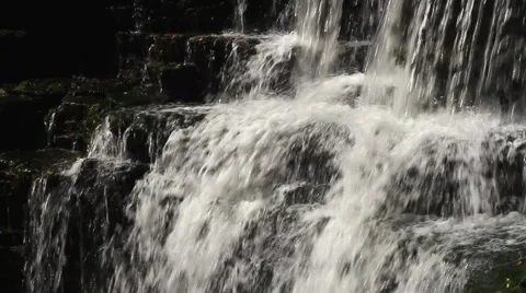 Close up of a small waterfall, water flowing over rocks Stock Footage 43053006