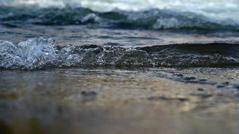 Close up of small waves breaking on the coast Video stock 128957480