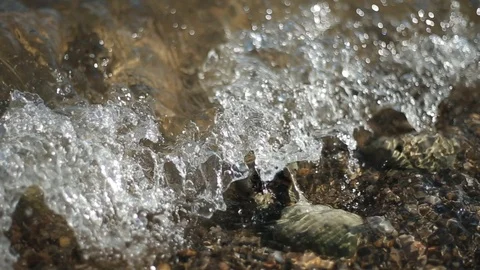 Close Up Small waves hitting a rock Stock Footage 103075072