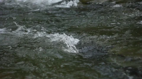 Close up small waves of river stream. Fast flow of water. Clear mountain river Video stock 130857045