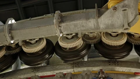 Close up small wheels of funicular mechanism spin and gives movement to cabins Video stock 225797751